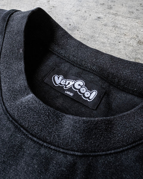 Close up on a crew neck shirt tag that says 'Very Cool Large'